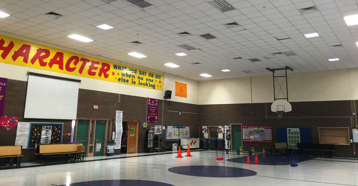 Clovis Municipal School District A school gymnasium lit by LED troffers