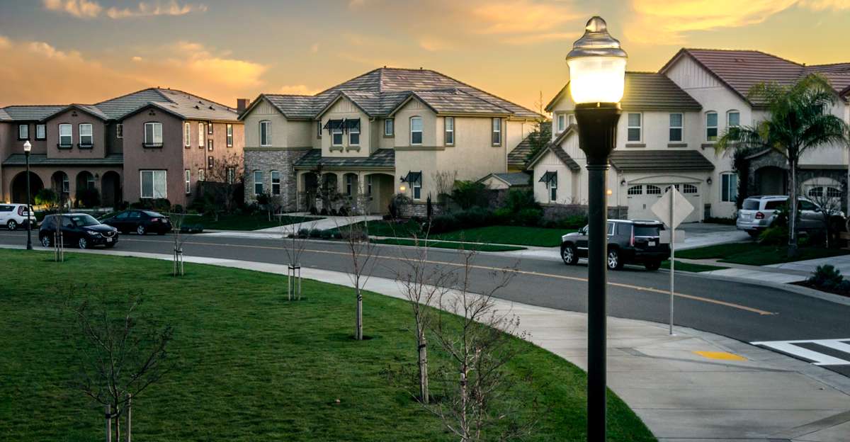 An illuminated LED streetlight at sunset