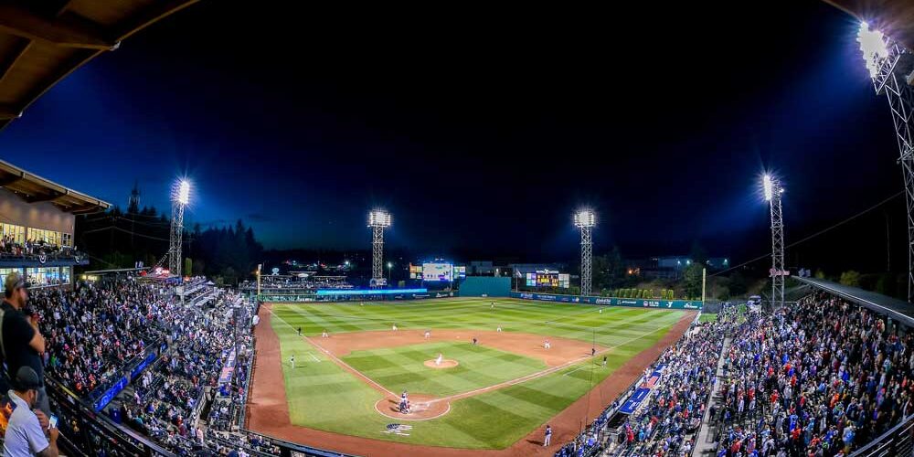 A panoramic shot of a baseball park, which is evenly lit by LED sports lighting surrounding the field