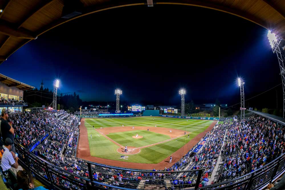 A panoramic shot of a baseball park, which is evenly lit by LED sports lighting surrounding the field