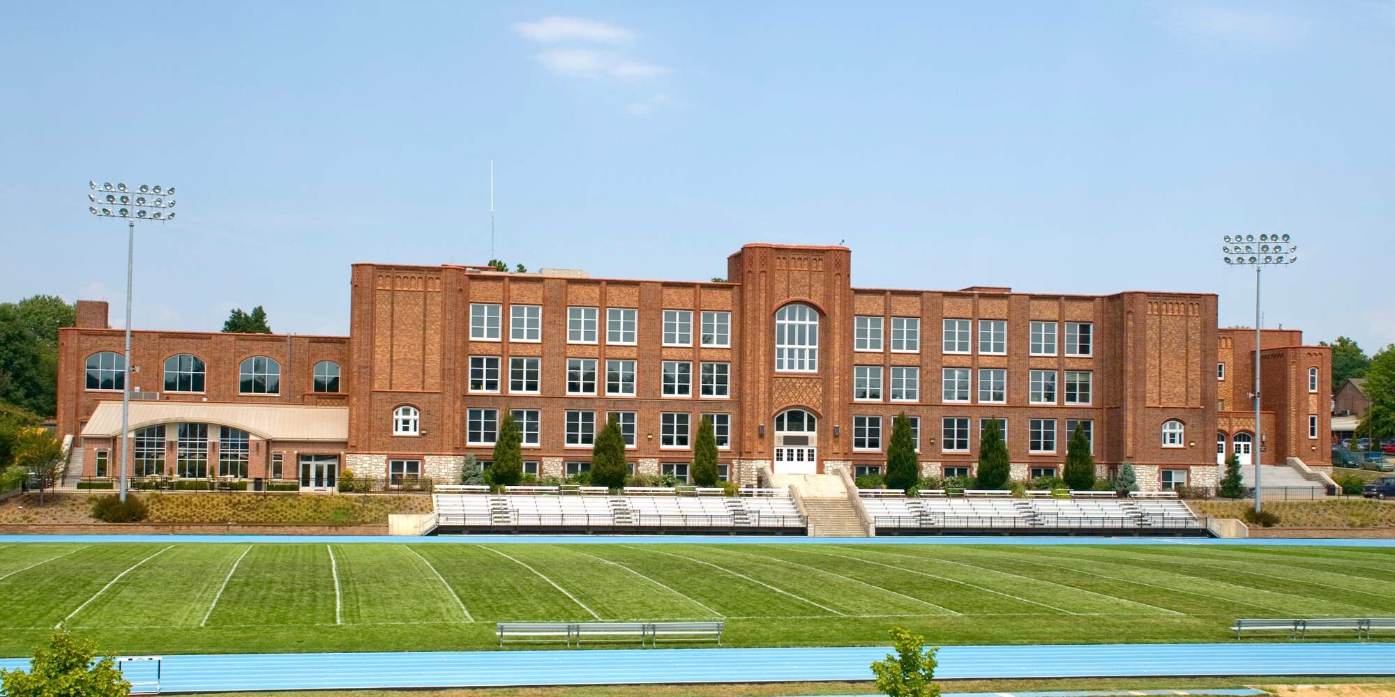 High mast sports lighting stands on either side of a high school football field