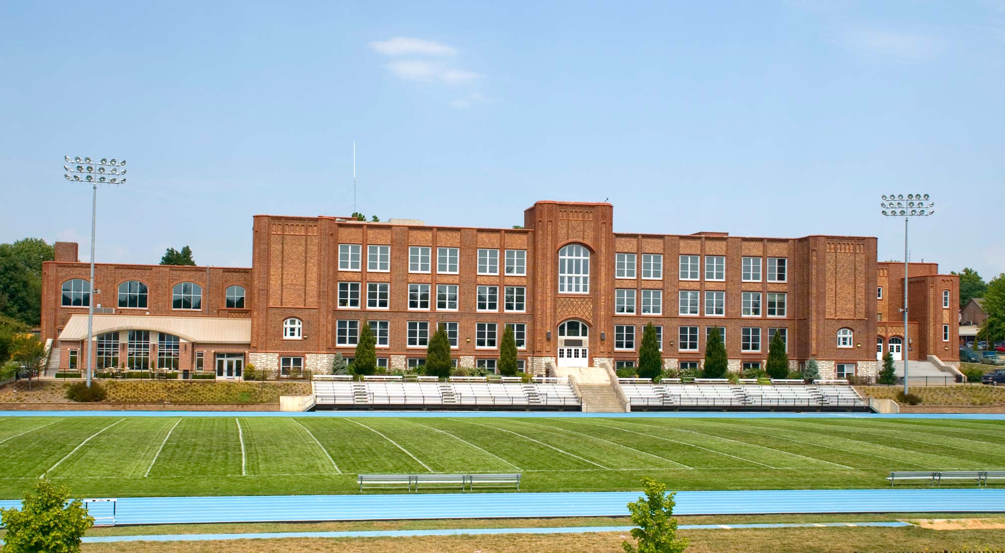 High mast sports lighting stands on either side of a high school football field