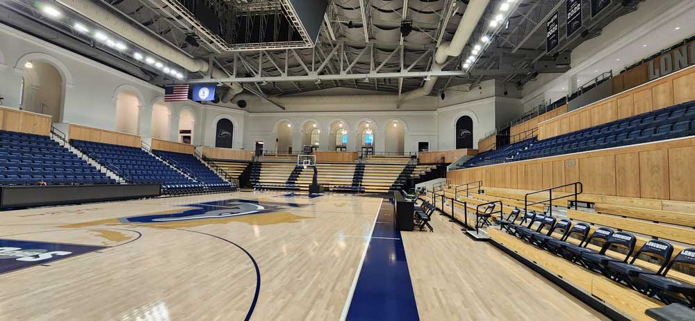 Longwood University An empty university basketball court, illuminated by rows of high bay LED light fixtures