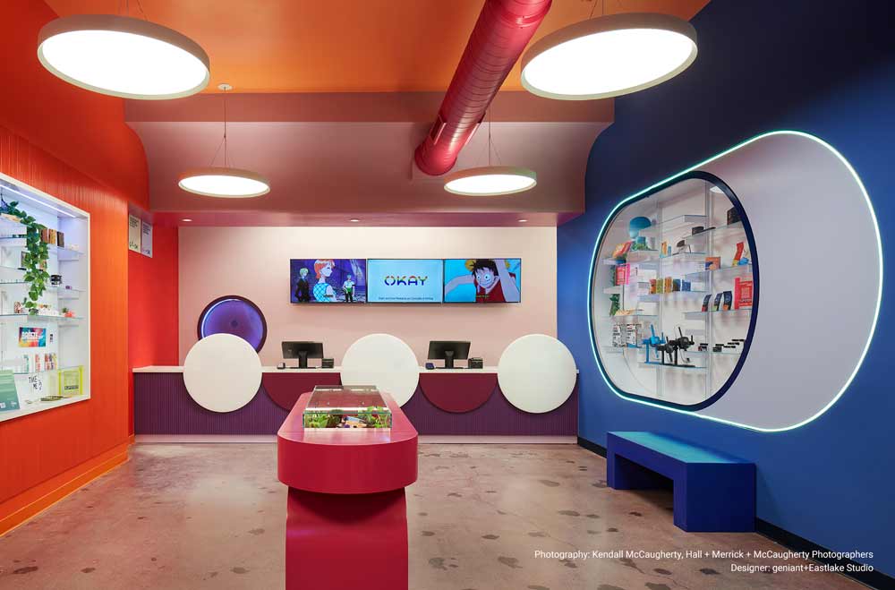 Okay Dispensary Circular pendant lights illuminate merchandise inside a bright and modern dispensary