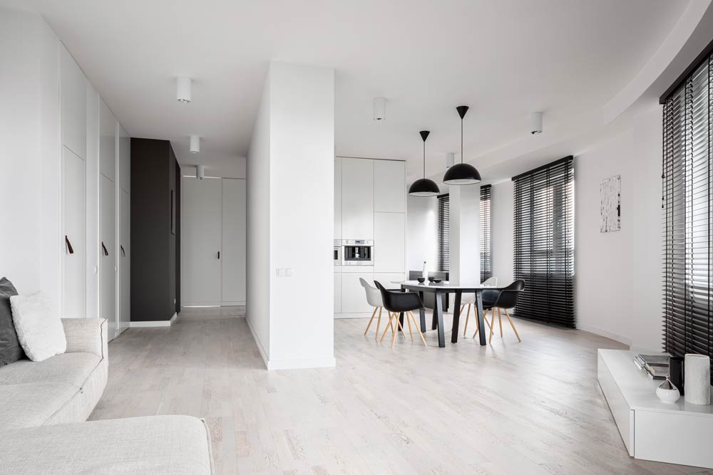 Residential Lighting Flush-mount cylindrical downlights and black shaded pendant lights provide illumination and ambiance to an apartment