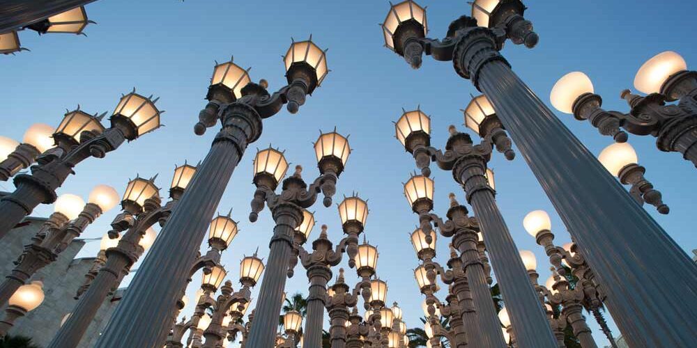 Classic city streetlamps are arranged to form a public art installation